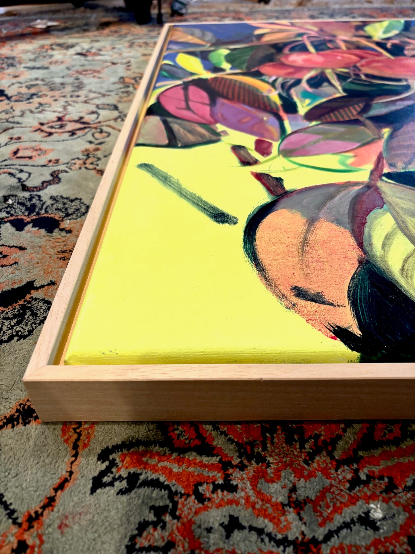 Colorful abstract painting in a wooden frame.